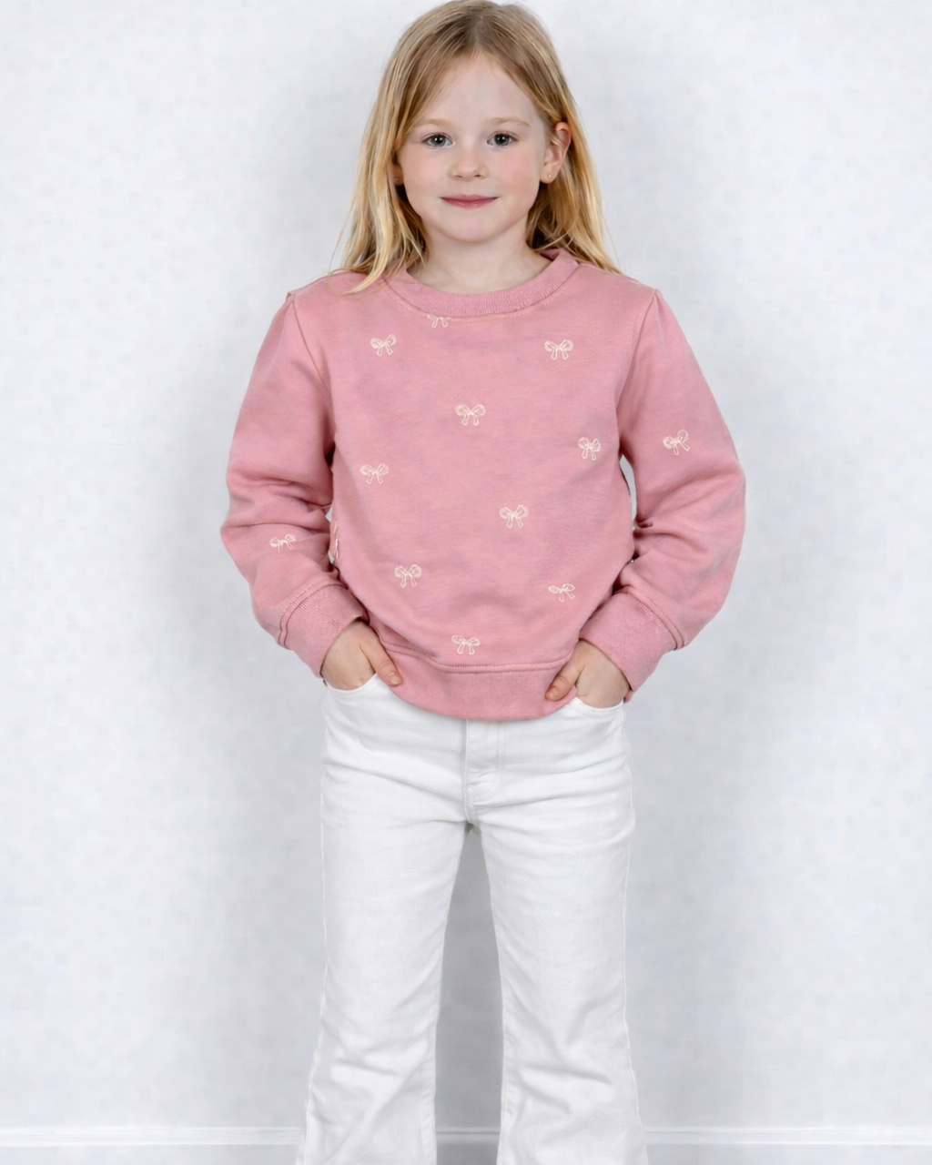 Roze trui met strikjes