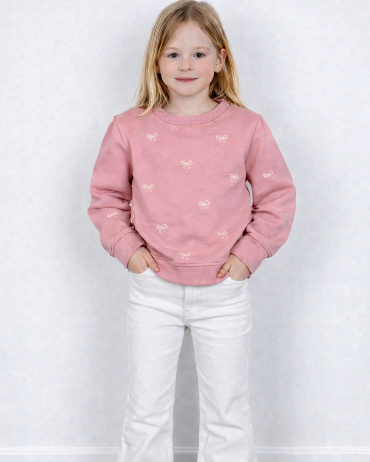 Roze trui met strikjes