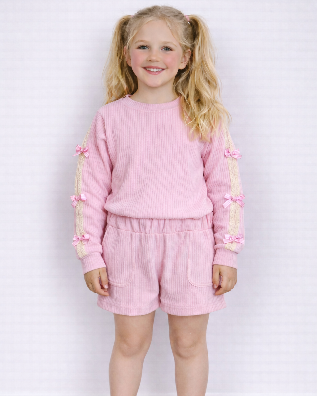 Trui roze met strikjes
